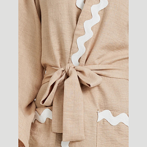 Beige robe with white lace trim on a light gray background