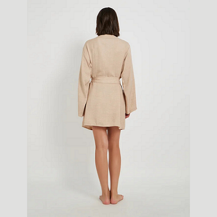 Woman wearing a beige robe on a white background