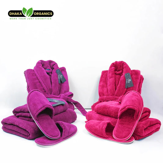 Luxury couple bathroom set with purple and dark pink velour bathrobes, towels, and slippers